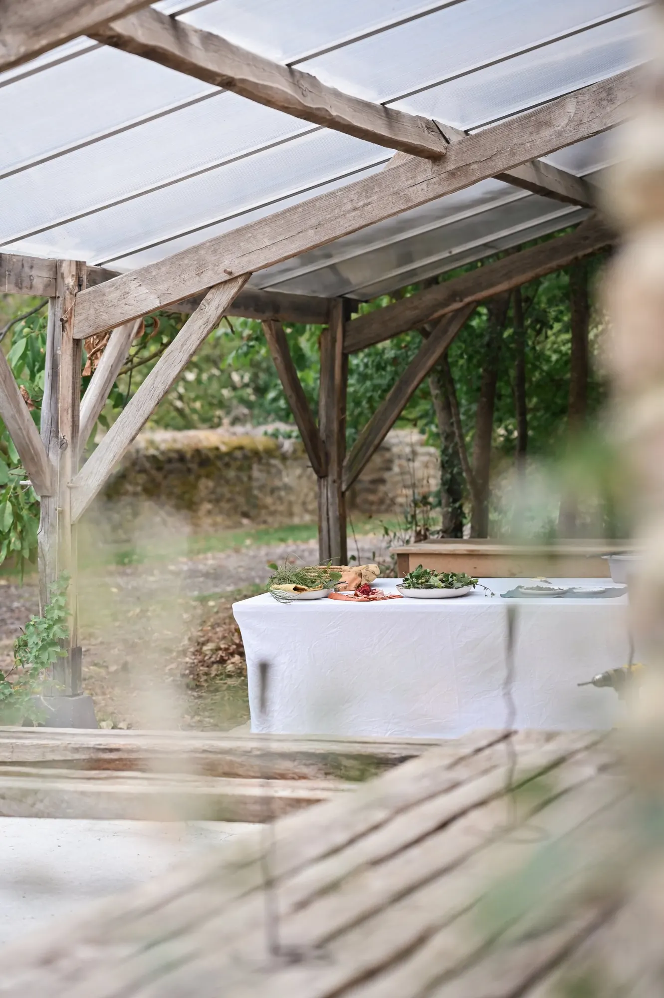 A table set for a workshop under the greenhouse roof